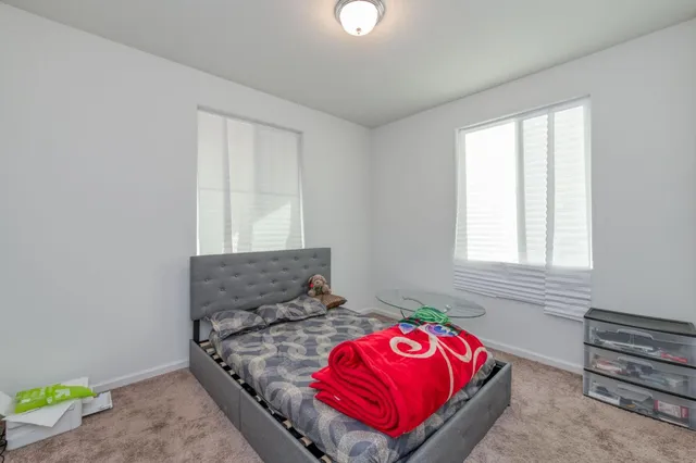 a bedroom with a bed and a window