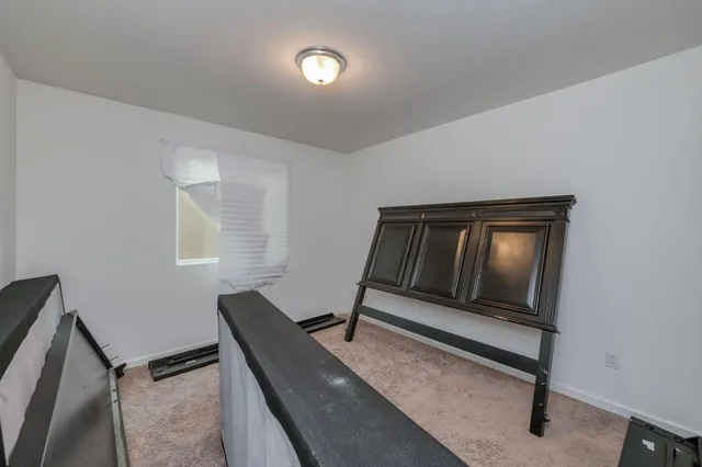 a living room with a bed furniture and a window