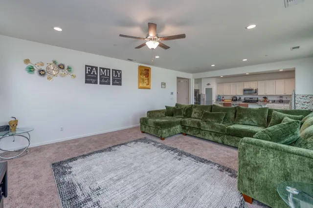 a living room with furniture and a chandelier