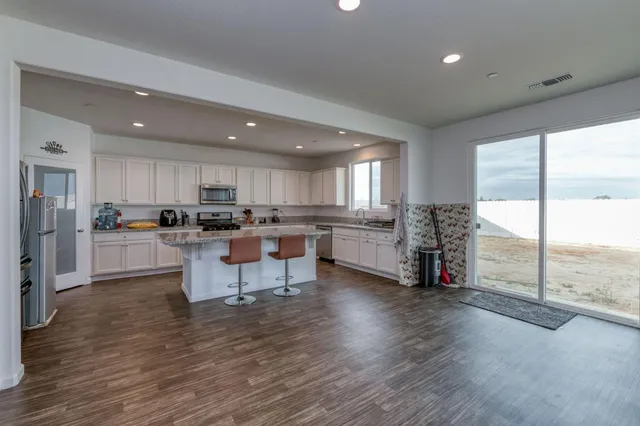 a kitchen with a refrigerator and a counter top space