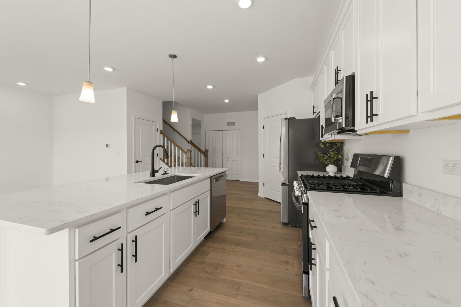 4486 Chelsea Mnr Circle Aurora, IL 60504 - Photo 11 of 23 a kitchen with stainless steel appliances a sink and a stove
