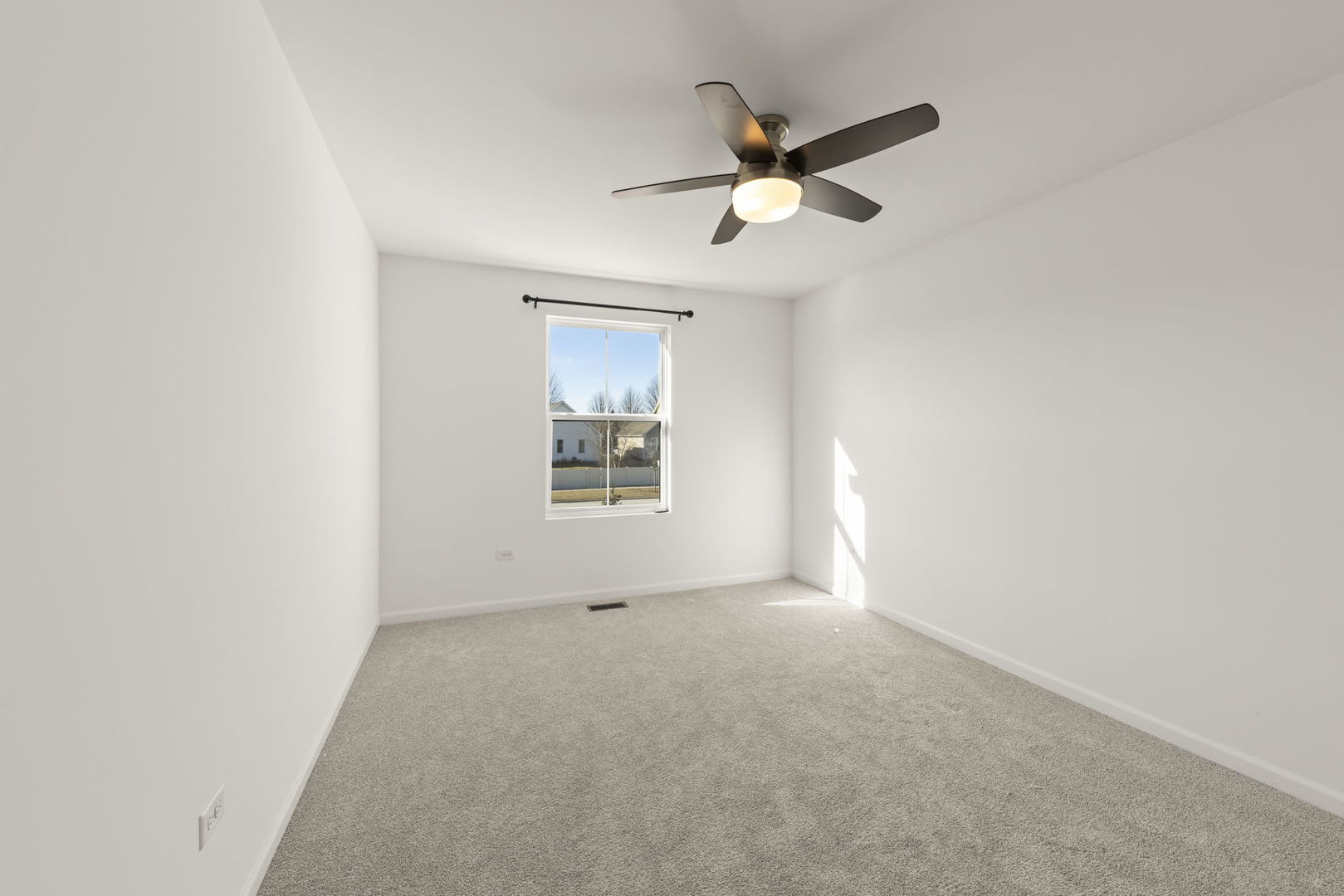 4486 Chelsea Mnr Circle Aurora, IL 60504 - Photo 21 of 23 an empty room with windows and fan