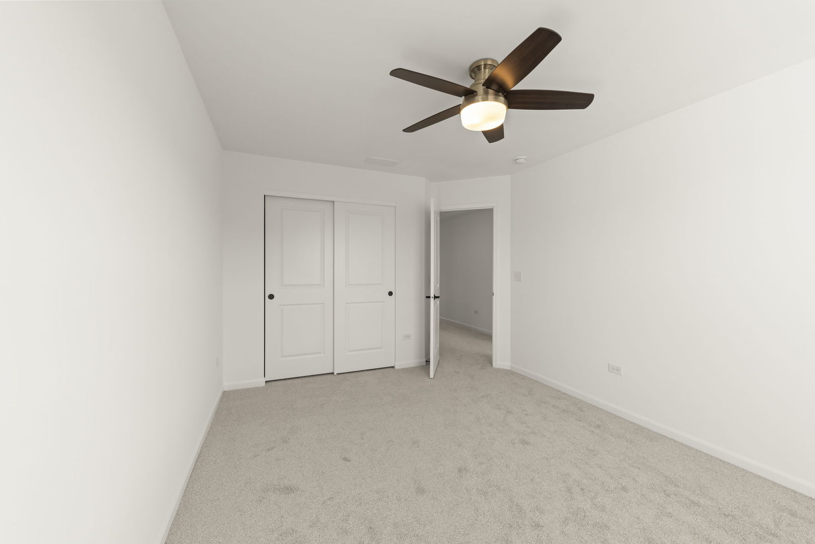 4486 Chelsea Mnr Circle Aurora, IL 60504 - Photo 22 of 23 an empty room with a ceiling fan and a window