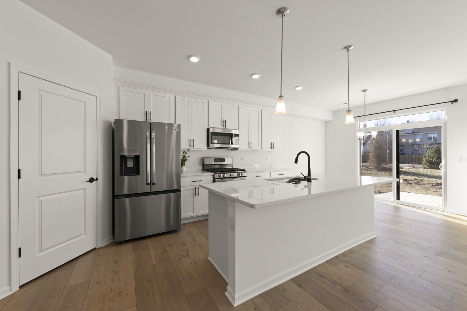 4486 Chelsea Mnr Circle Aurora, IL 60504 - Photo 4 of 23 a kitchen with stainless steel appliances granite countertop a refrigerator a sink dishwasher a stove and a refrigerator with wooden floor