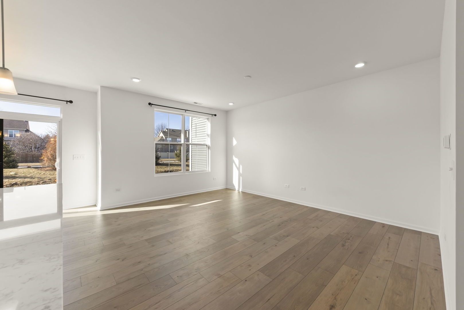 4486 Chelsea Mnr Circle Aurora, IL 60504 - Photo 5 of 23 a view of an empty room with wooden floor and a window