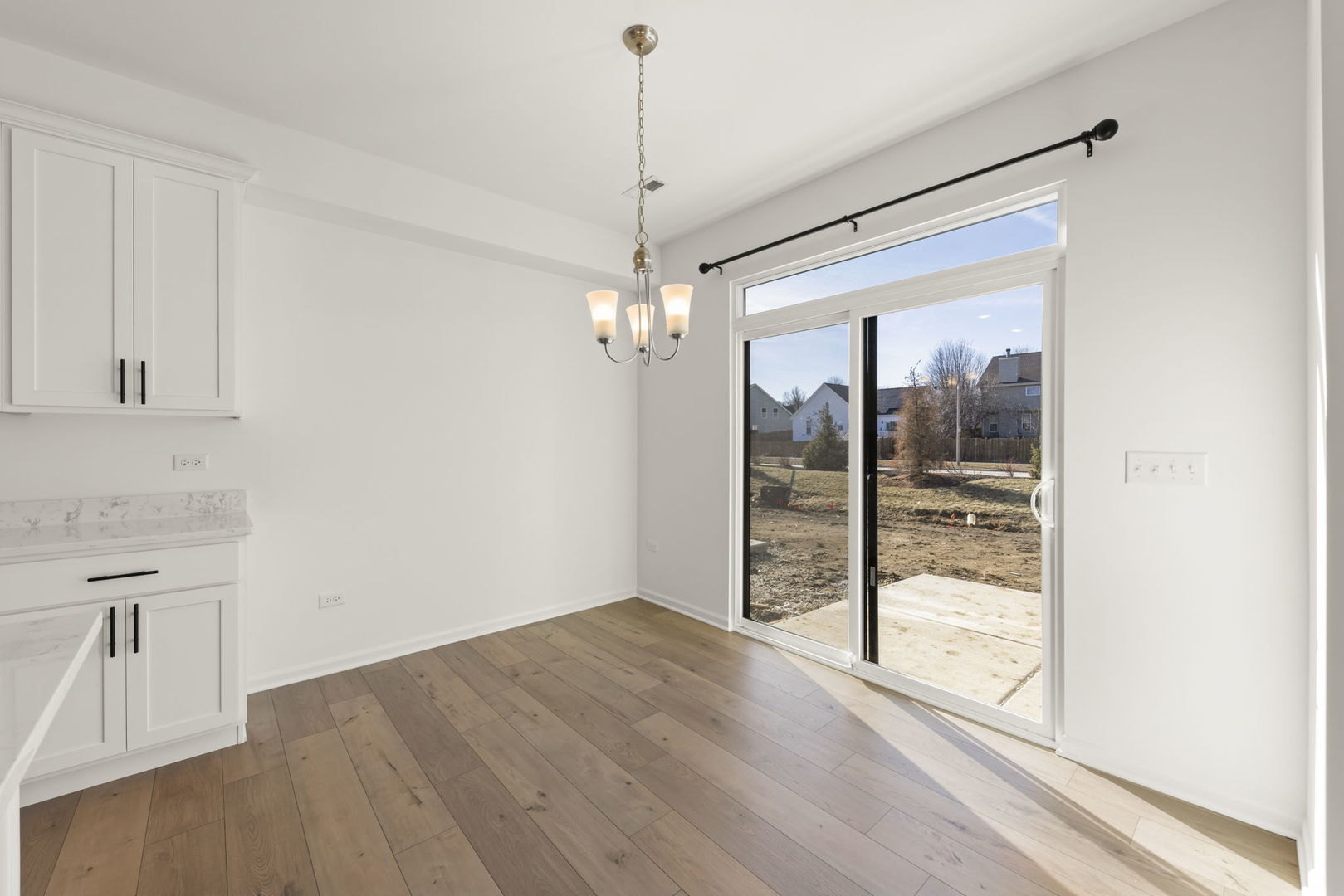 4486 Chelsea Mnr Circle Aurora, IL 60504 - Photo 8 of 23 a view of a room with wooden floor and windows