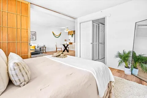 a bedroom with a bed and dresser with mirror