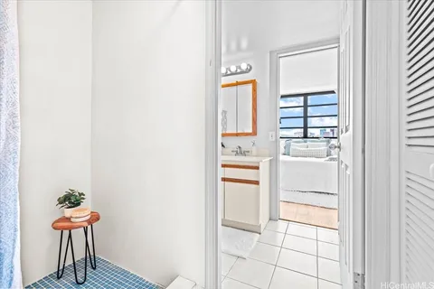 a kitchen with white cabinets and window