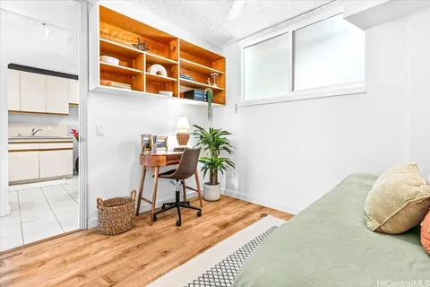 a work room with furniture and a potted plant
