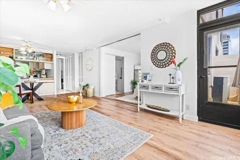 a living room with furniture a rug and a clock