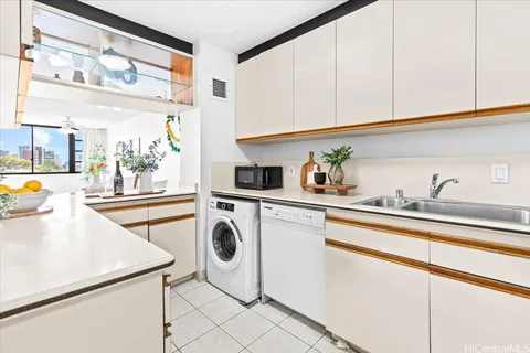 a kitchen with a sink a stove and cabinets