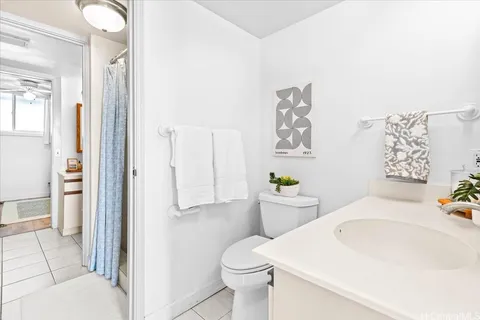 a white toilet sitting next to a bathroom sink
