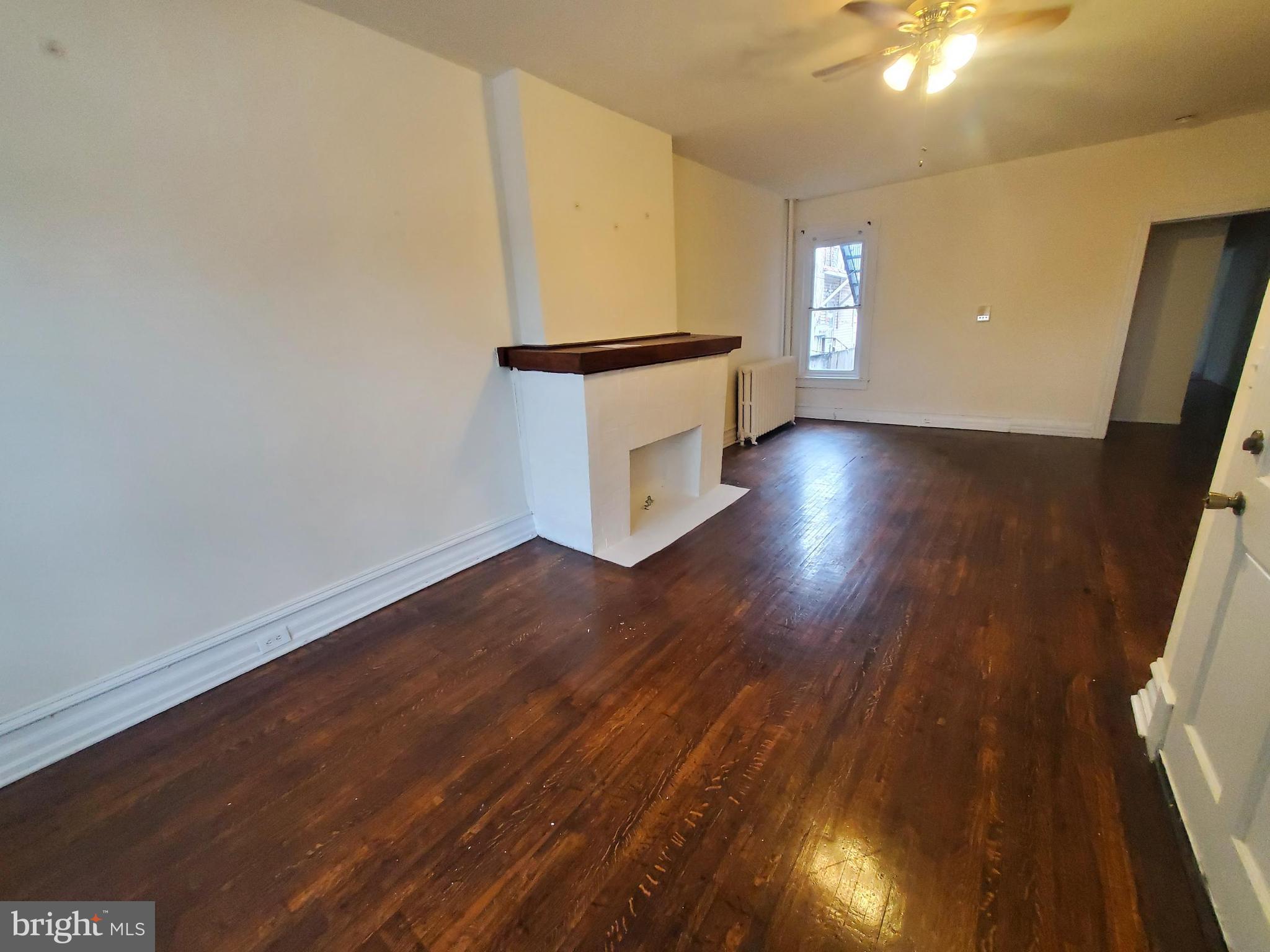 315 North 6th Street, Unit 1 Reading, PA 19601 - Photo 4 of 9 wooden floor in an empty room with a window