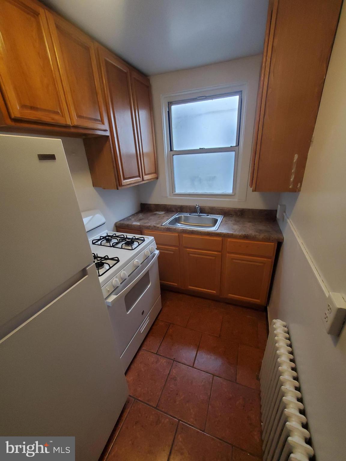 315 North 6th Street, Unit 1 Reading, PA 19601 - Photo 6 of 9 a kitchen with granite countertop a sink a stove and cabinets