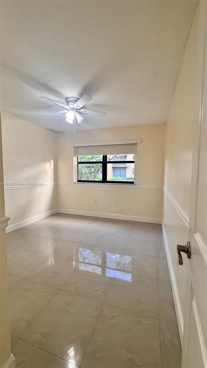 15610 Southwest 80th Street, Unit J104 Miami, FL 33193 - Photo 13 of 16 a view of a livingroom with a ceiling fan and window