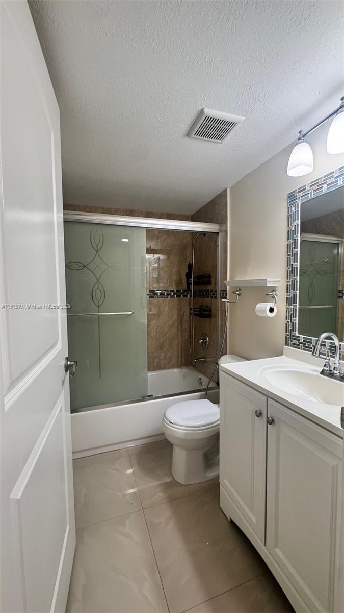 15610 Southwest 80th Street, Unit J104 Miami, FL 33193 - Photo 15 of 16 a bathroom with a toilet a sink and shower