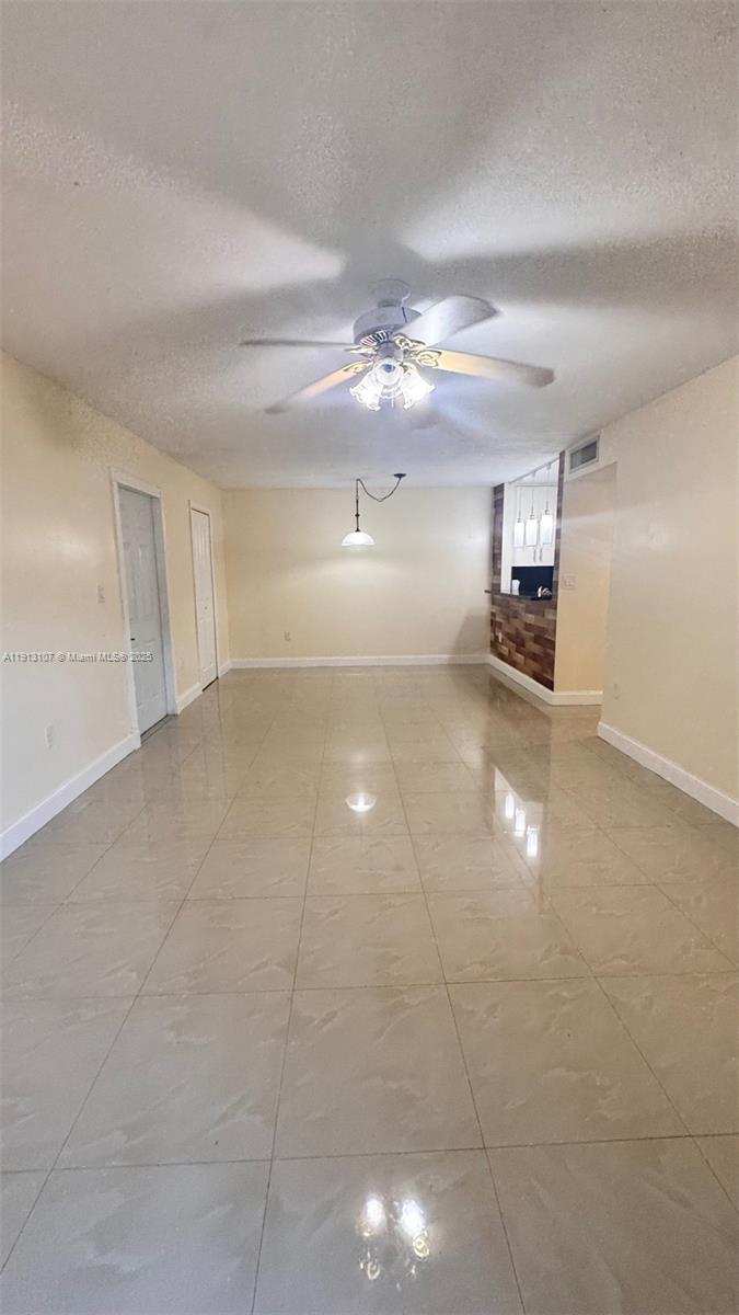 15610 Southwest 80th Street, Unit J104 Miami, FL 33193 - Photo 2 of 16 a view of a kitchen with a sink and chandelier fan