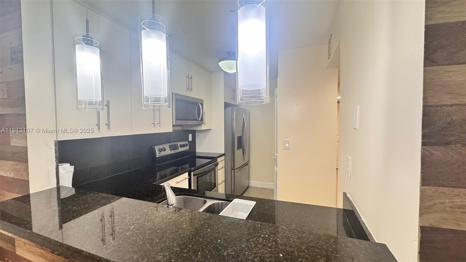 15610 Southwest 80th Street, Unit J104 Miami, FL 33193 - Photo 3 of 16 a view of a kitchen cabinets
