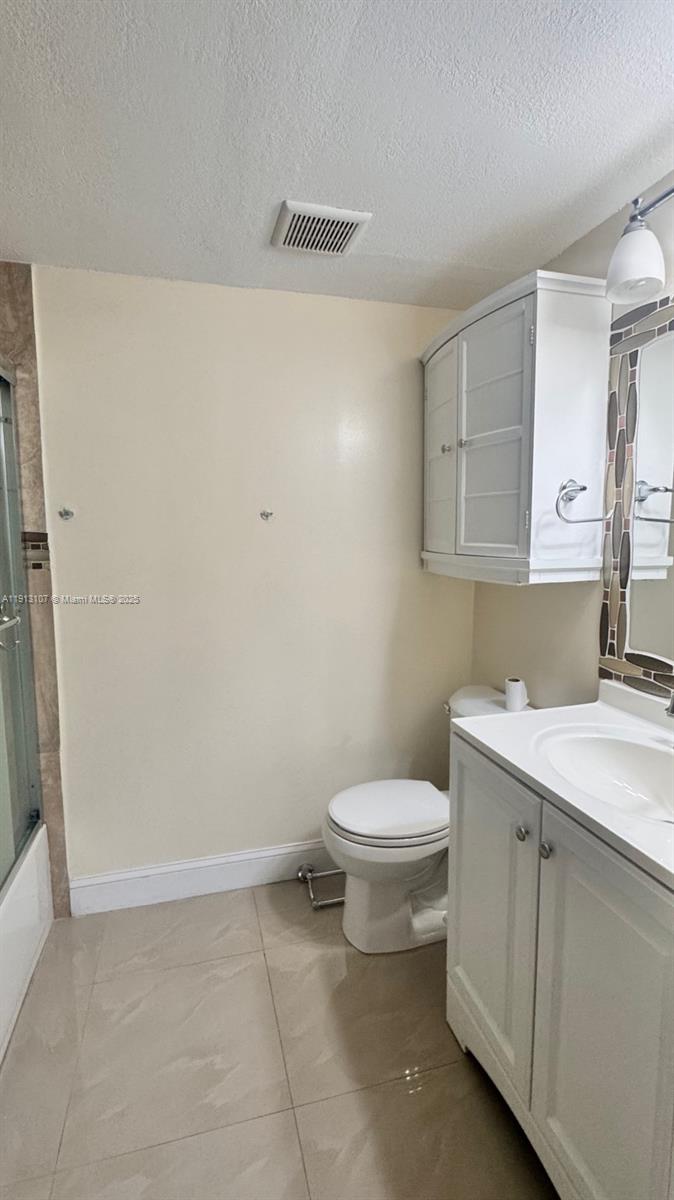 15610 Southwest 80th Street, Unit J104 Miami, FL 33193 - Photo 10 of 16 a bathroom with a toilet sink and mirror