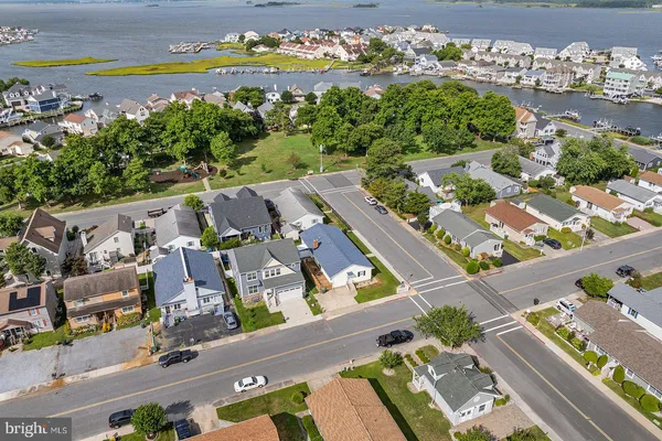 an aerial view of a house with a garden and lake view