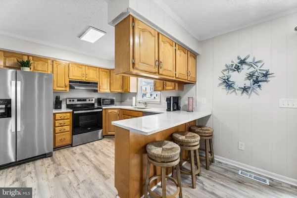 a kitchen with a table chairs stove and cabinets