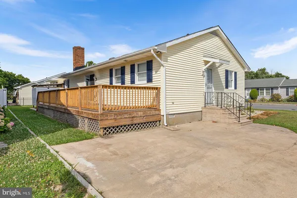 a front view of a house with a garden and plants