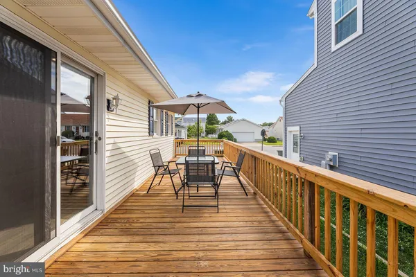 a view of a balcony with two chairs and wooden floor