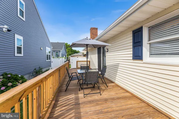 a balcony with wooden floor and furniture
