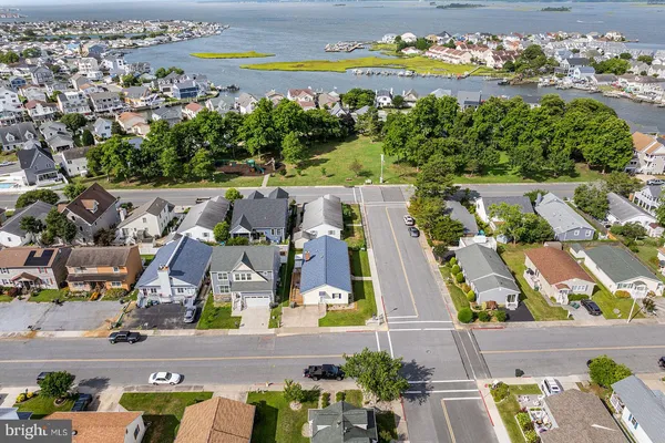 an aerial view of residential houses with city view