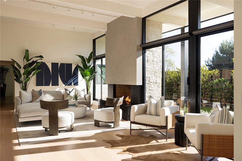 32602 Crete Road Dana Point, CA 92629 - Photo 3 of 41 Walking through the custom 10 foot pivot door into the perfect mid century living area complete with high ceiling, natural light , modern gas fireplace and wood flooring.