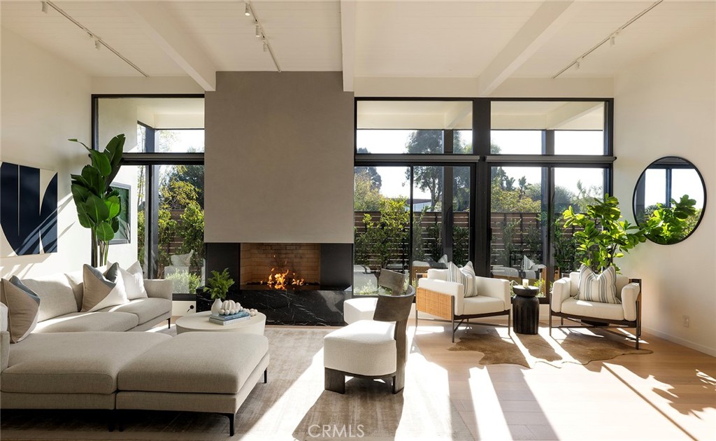 32602 Crete Road Dana Point, CA 92629 - Photo 4 of 41 Walking through the custom 10 foot pivot door into the perfect mid century living area complete with high ceiling, natural light , modern gas fireplace and wood flooring.