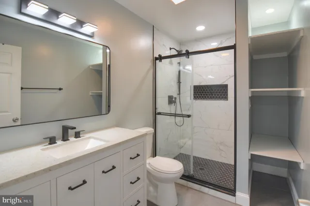a bathroom with a sink toilet and shower