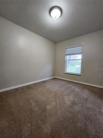 an empty room with a empty space and windows