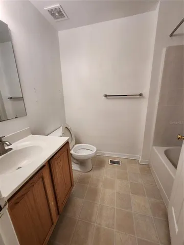 a bathroom with a sink a toilet and bathtub