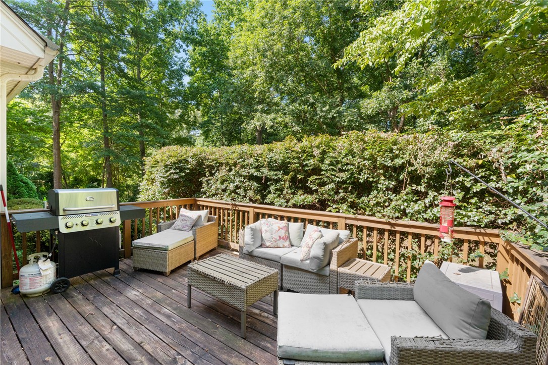 108 Winterbrook Circle Seneca, SC 29678 - Photo 31 of 40 A spacious wooden deck provides ample room for outdoor entertaining amidst lush greenery.