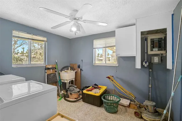 a room with furniture a chandelier and a window