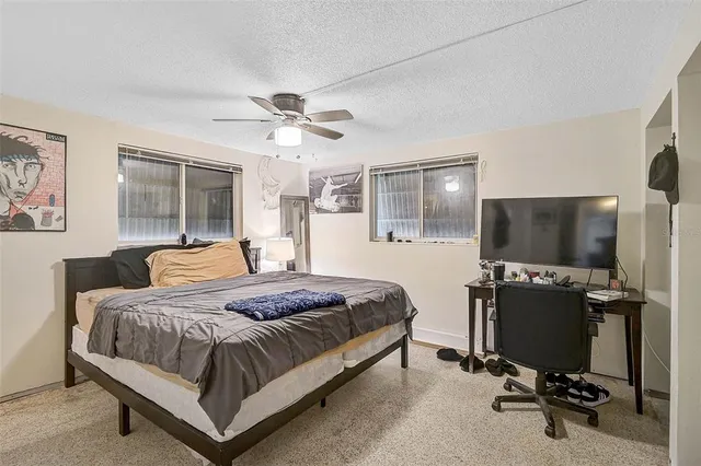 a bedroom with a bed and a flat screen tv