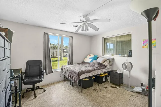 a bedroom with bed and a window