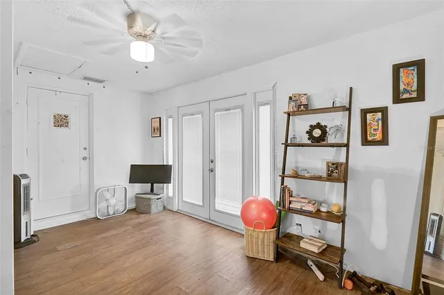 a view of a workspace with furniture and wooden floor