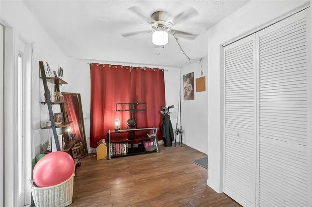 a view of a room with a refrigerator and a chandelier