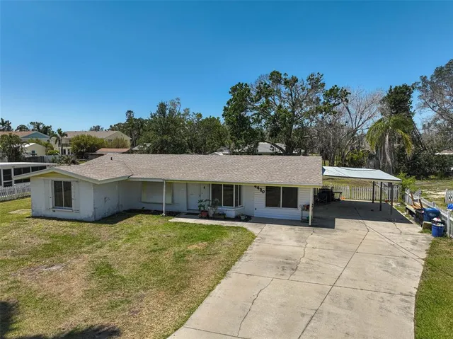 a view of a house with pool and a yard