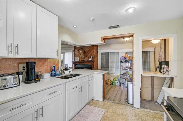 a kitchen with cabinets and window