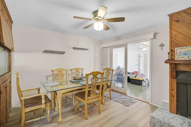 a dining room with furniture a chandelier and wooden floor