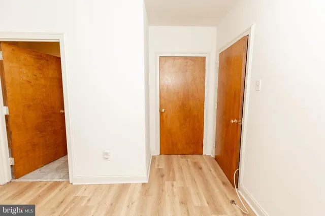 a view of a room with wooden floor