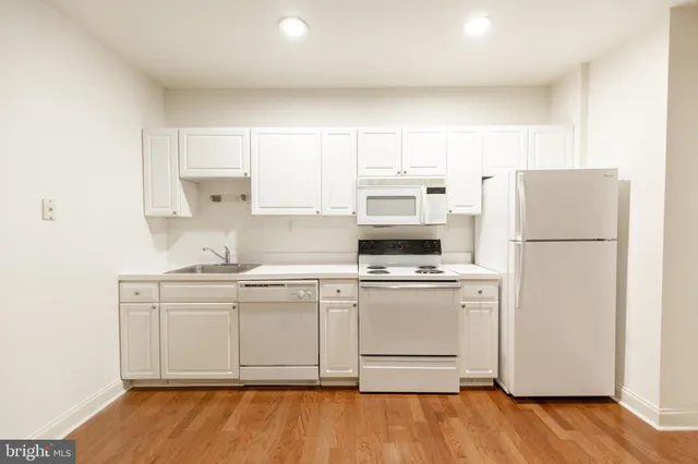 a kitchen with stainless steel appliances a refrigerator stove microwave and cabinets