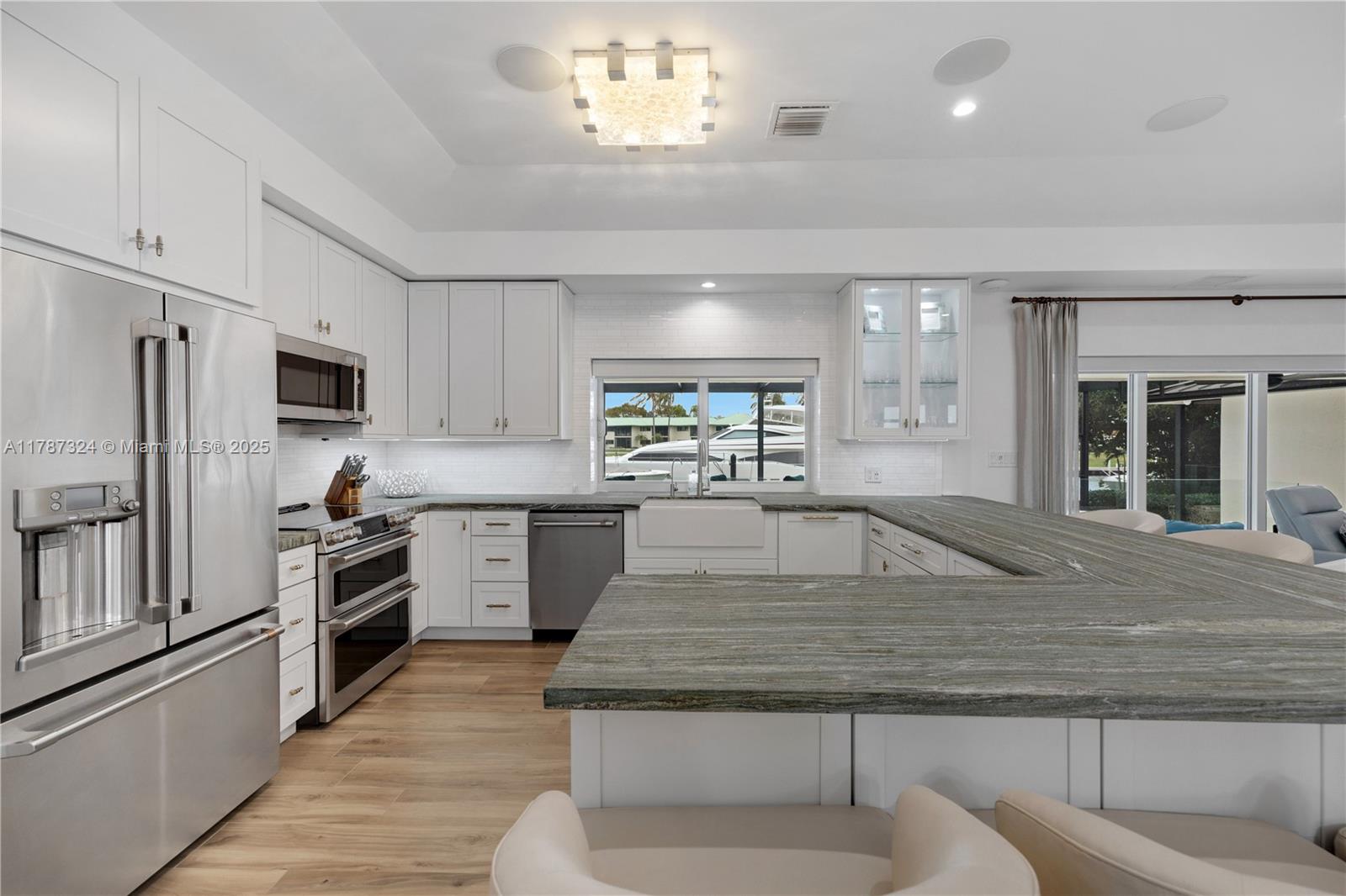 64 Tarpon Lane Key Largo, FL 33037 - Photo 5 of 22 a kitchen with stainless steel appliances granite countertop a sink and a refrigerator