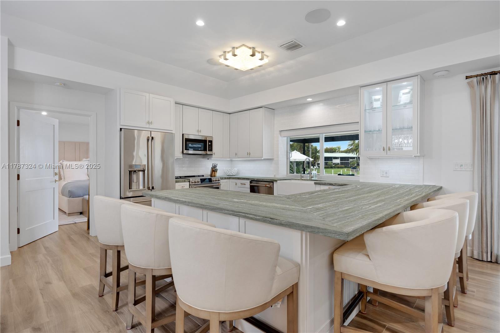 64 Tarpon Lane Key Largo, FL 33037 - Photo 6 of 22 a kitchen with stainless steel appliances granite countertop a table chairs refrigerator a sink and dishwasher