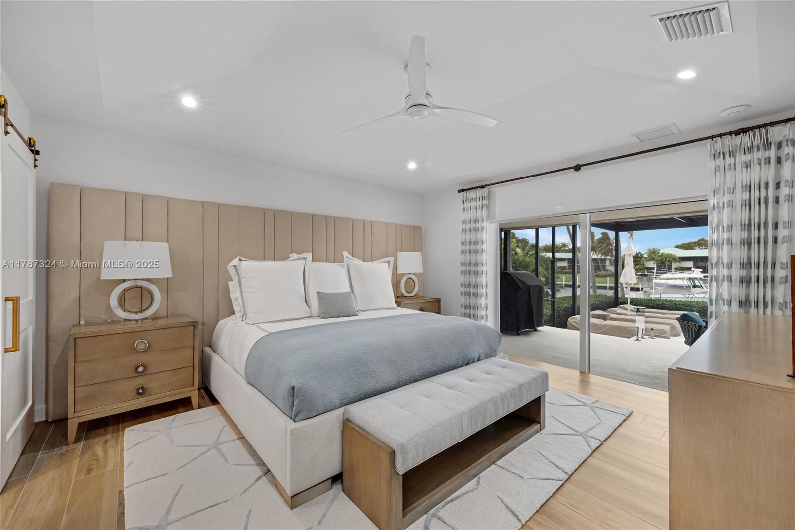 64 Tarpon Lane Key Largo, FL 33037 - Photo 9 of 22 a spacious bedroom with a large bed and a large window