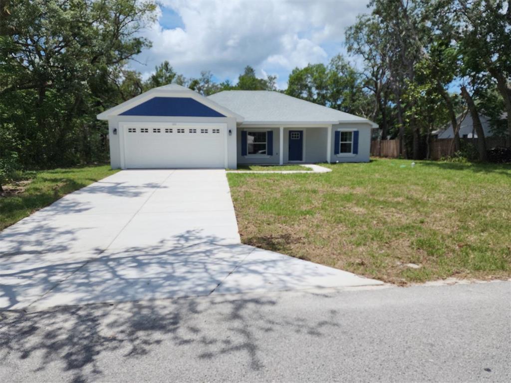 1111 Dagmar Avenue Spring Hill, FL 34606 - Photo 1 of 27 a front view of a house with a yard