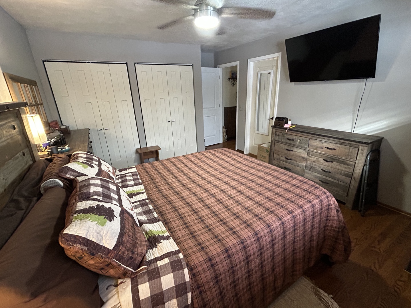 1403 West Beach Road Waukegan, IL 60087 - Photo 29 of 59 a bedroom with a bed a tv and wooden floor